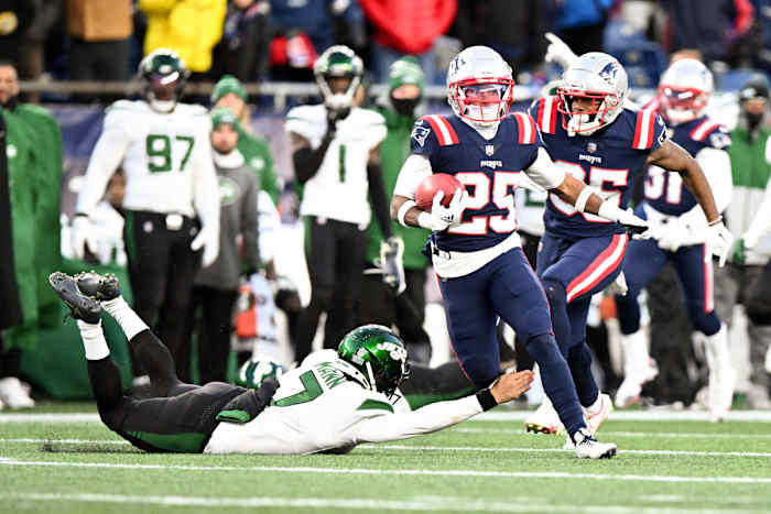 Jets' punter Braden Mann attempts to stop New England's Marcus Jones on the game-winning return